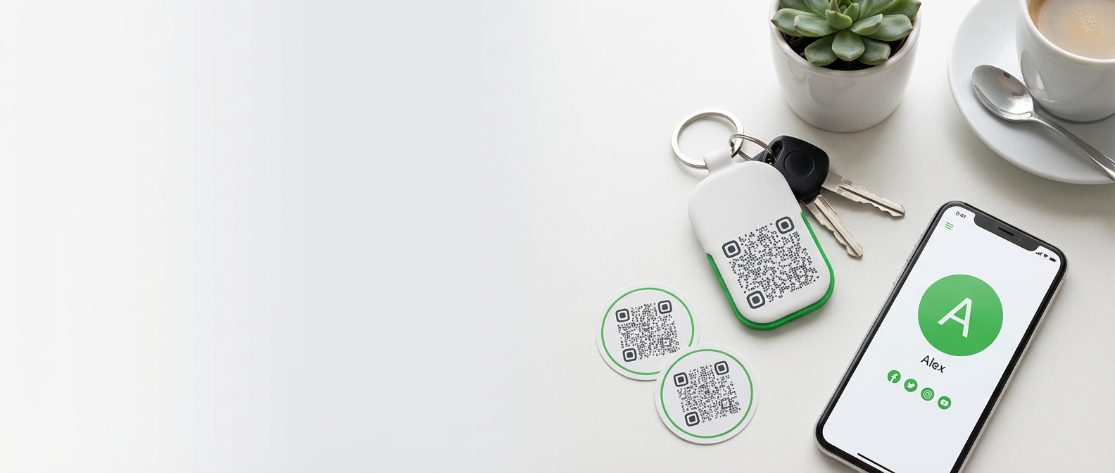 QR Me product flat lay with keychain, stickers, and phone